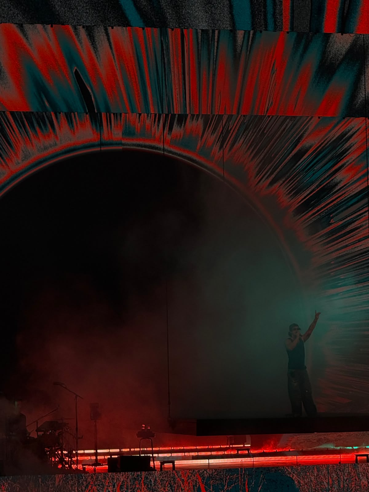 Solo performer against a red and teal video wall
